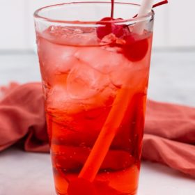 shirley temple in glass with cherry and straw