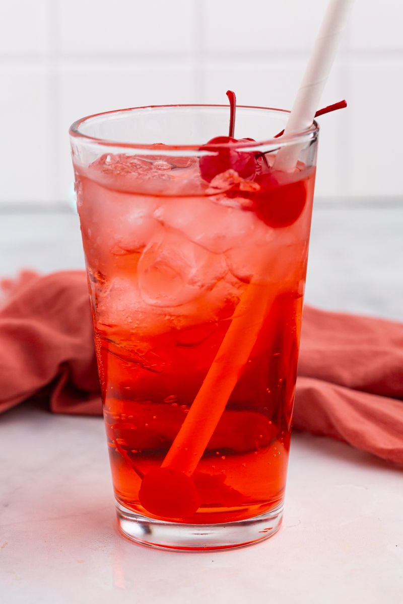 shirley temple in glass with cherry and straw