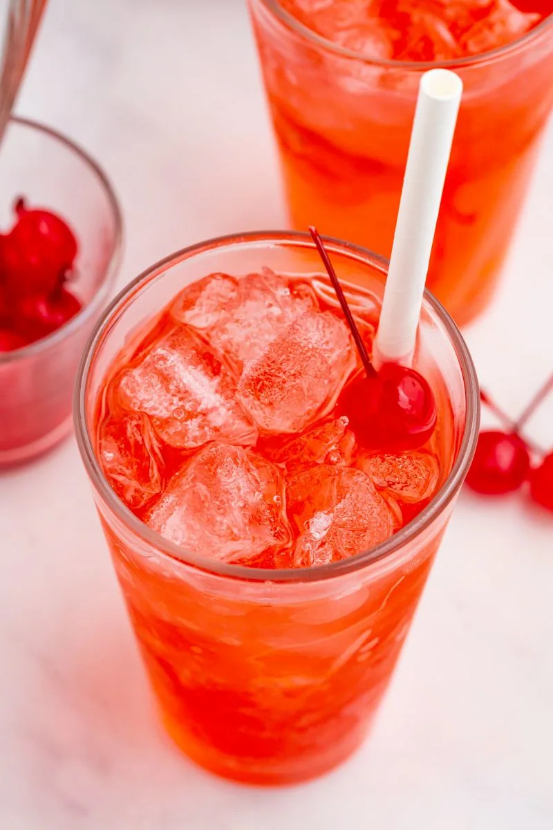 shirley temple beverage with cherry and straw