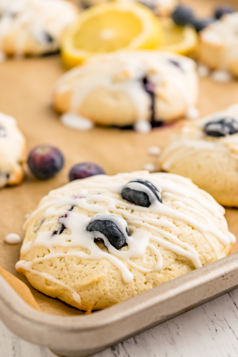 iced blueberry cookies on baking sheet