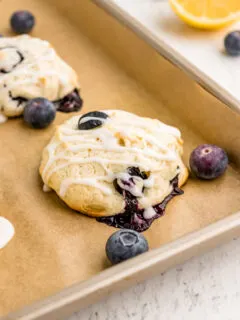 iced blueberry cookies on baking sheet