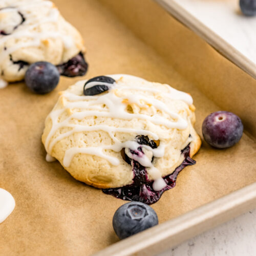 iced blueberry cookies on baking sheet