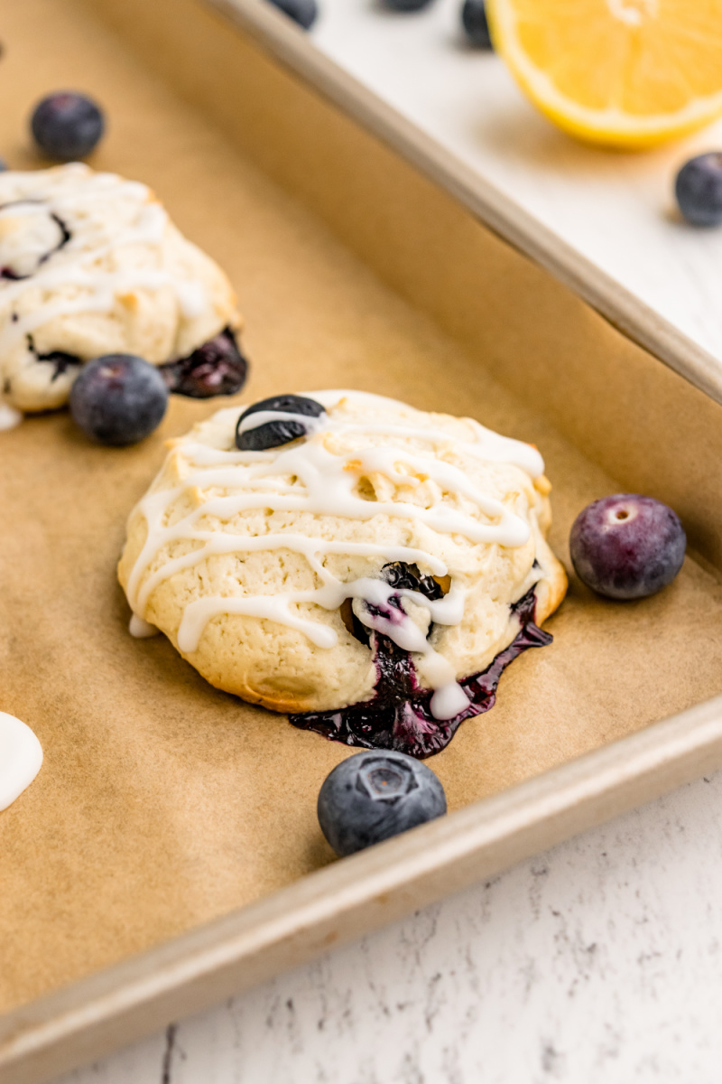 iced blueberry cookies on baking sheet