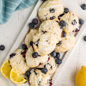 iced blueberry cookies piled on platter