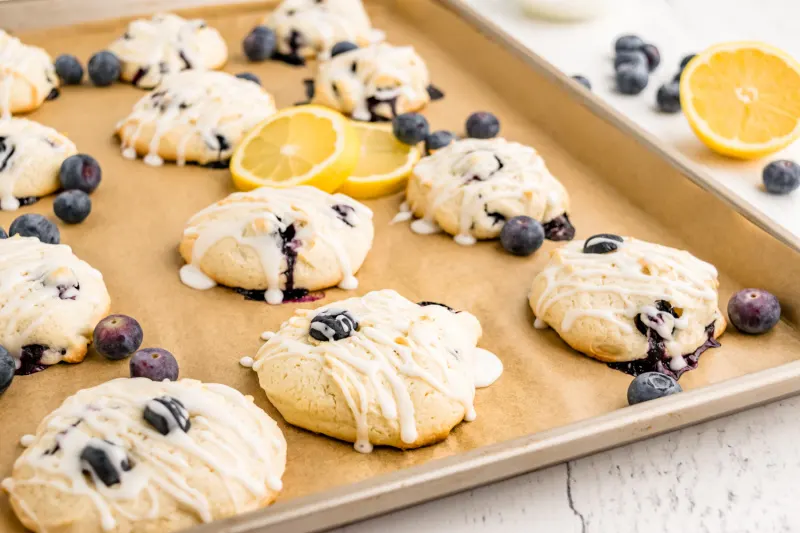iced blueberry cookies on baking sheet