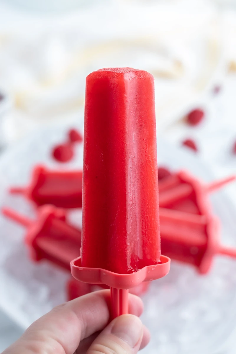 hand holding raspberry popsicle