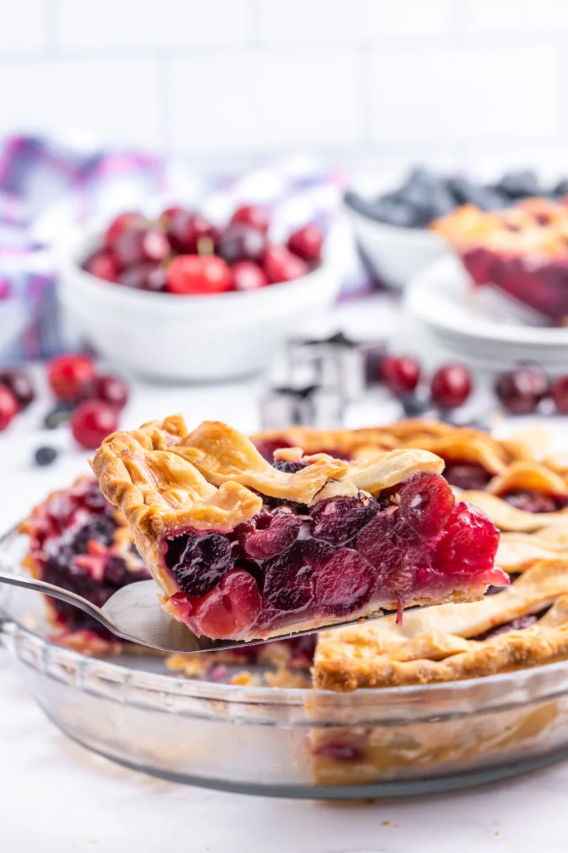 taking out slice of berry pie