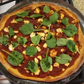 Bacon, spinach and goat cheese pizza