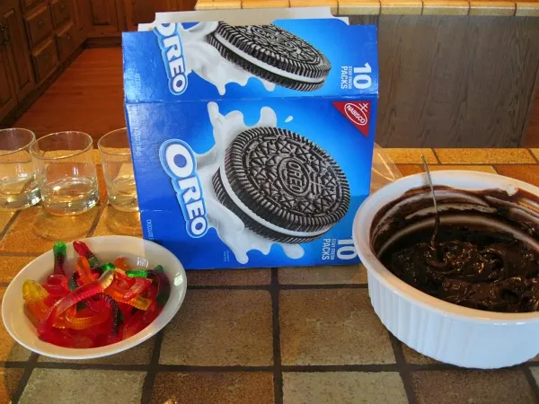 ingredients displayed for mud cups: gummy worms, OREOS and chocolate pudding