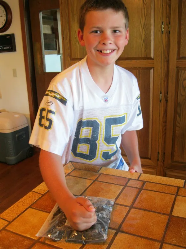 RecipeBoy crushing OREOs in a bag