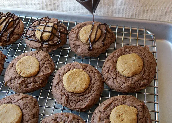 Peanut Butter Brownie Cookies getting chocolate drizzle