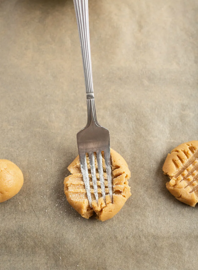 fork criss crossing peanut butter cookie dough