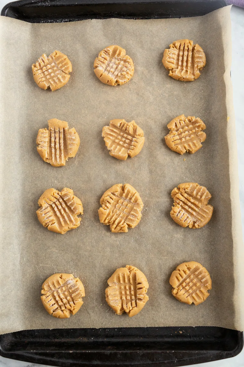 peanut butter cookies on a baking sheet waiting for oven