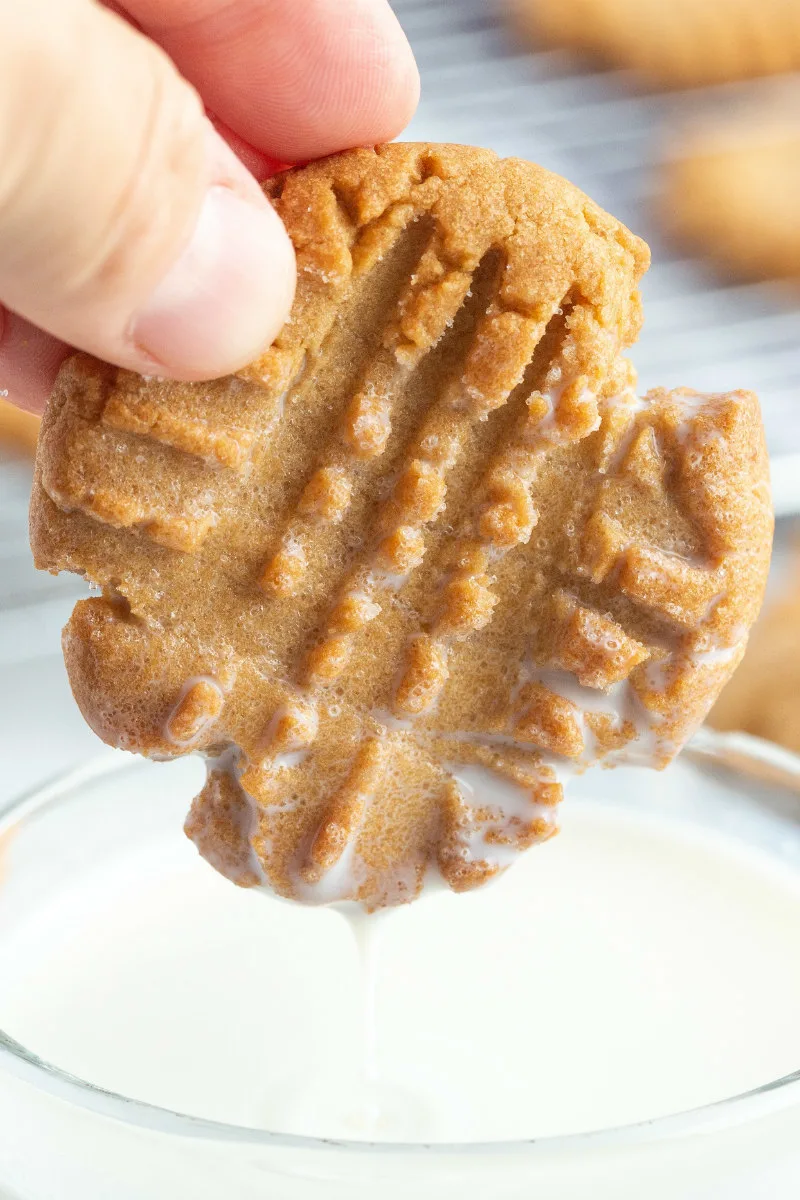 peanut butter cookie dipped in glass of milk