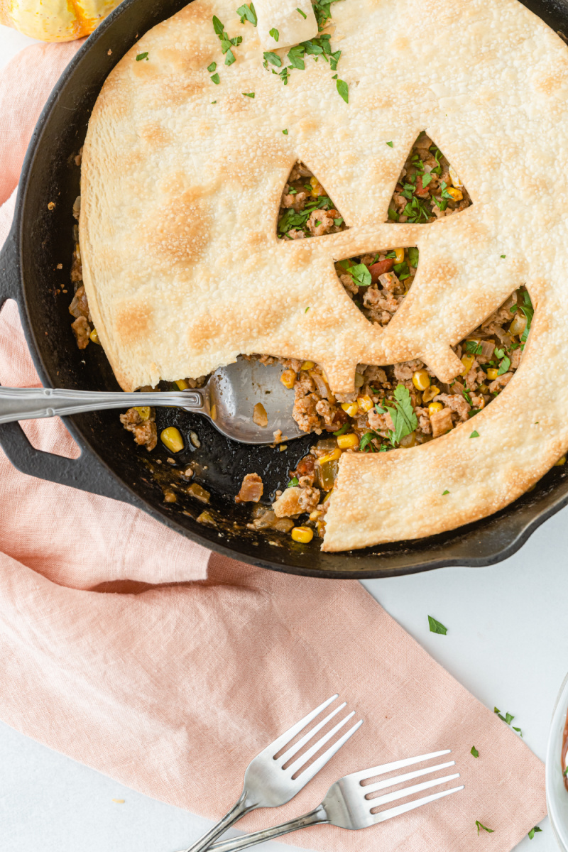 spooning out serving of jack o lantern sloppy joe pie