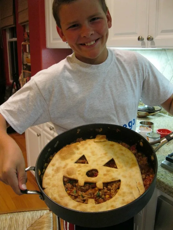 recipeboy holding skillet of jack o lantern sloppy joe pie