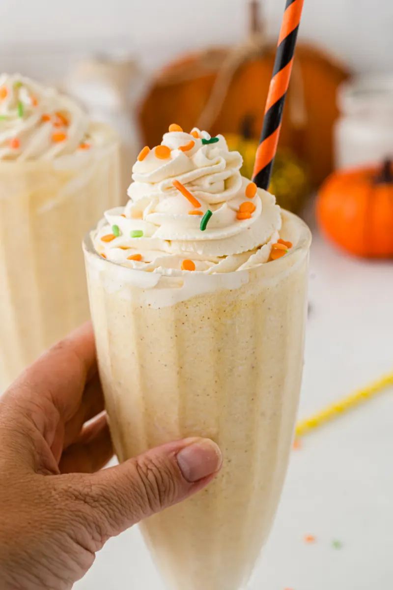 hand holding pumpkin pie milkshake