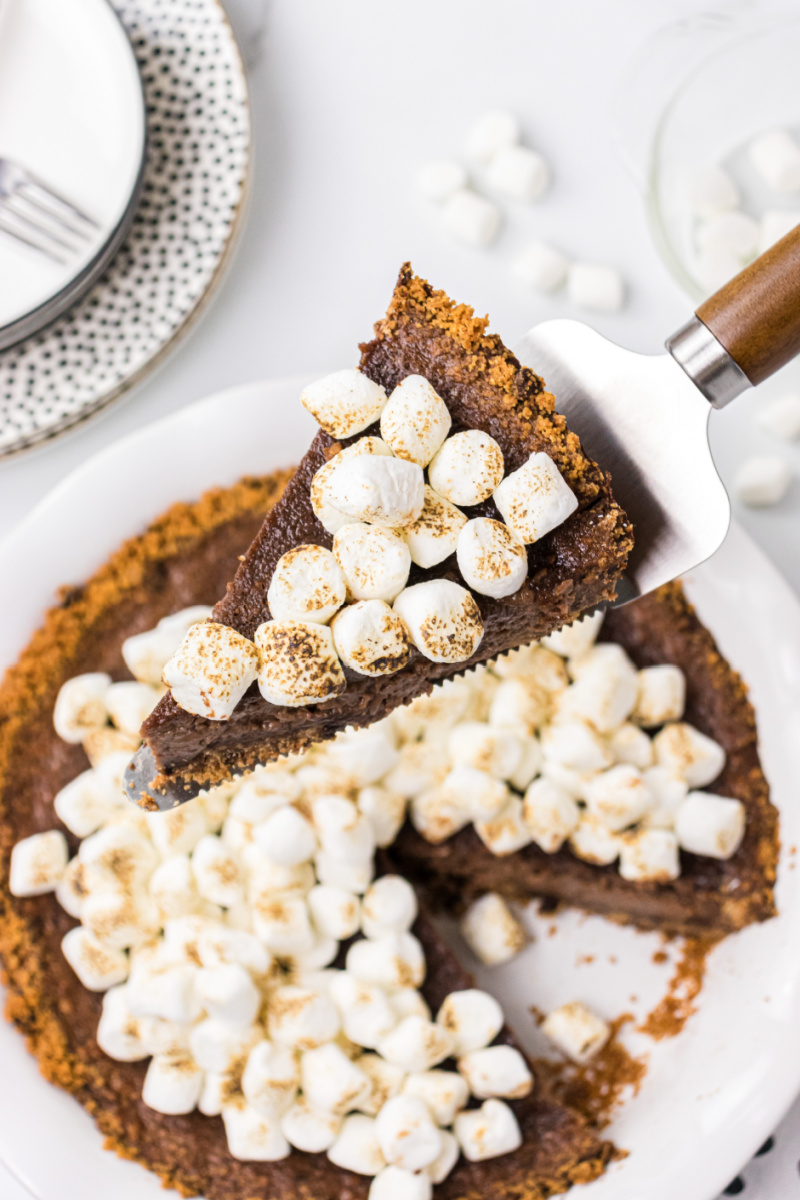 server taking out slice of S'Mores Pie