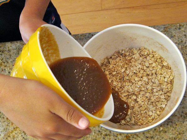 making Pumpkin Granola pouring liquid to add to oats