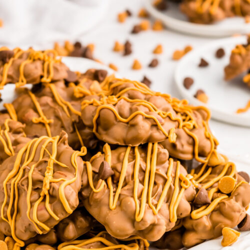 chocolate butterscotch peanut clusters stacked on white plate