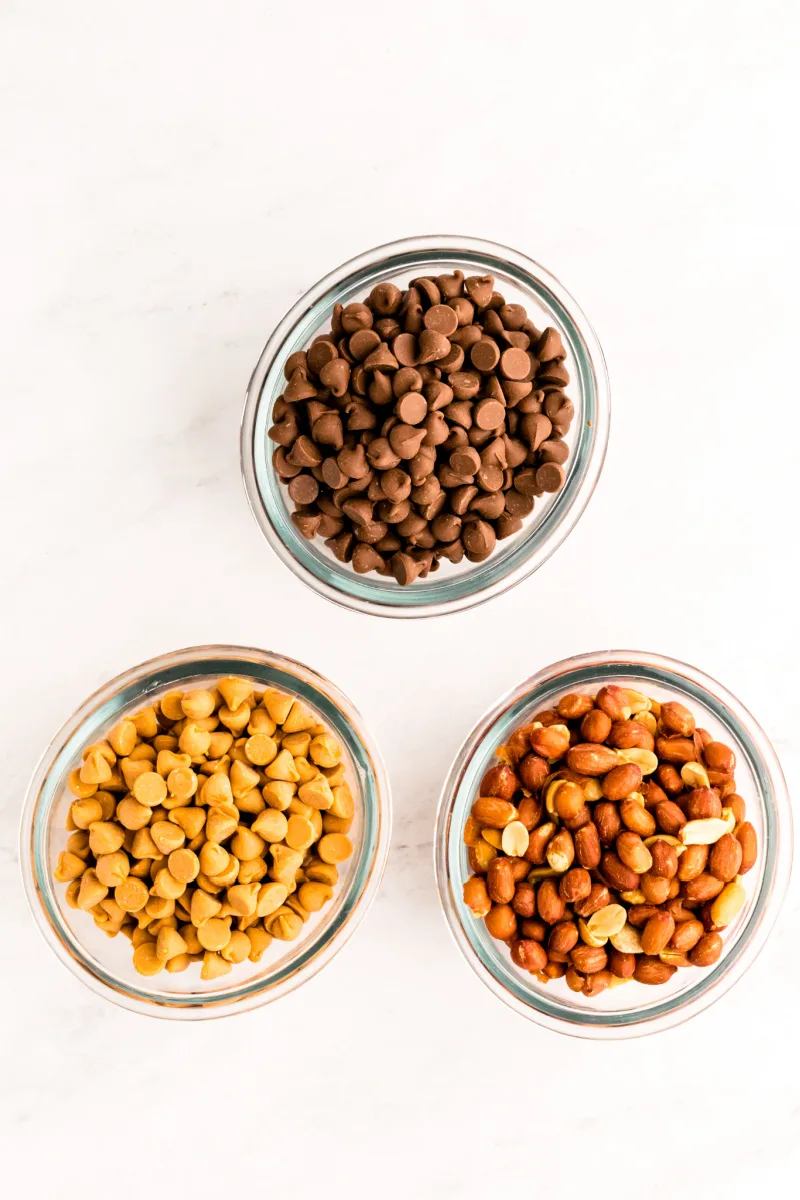 bowls of chocolate chips, peanuts and butterscotch chips
