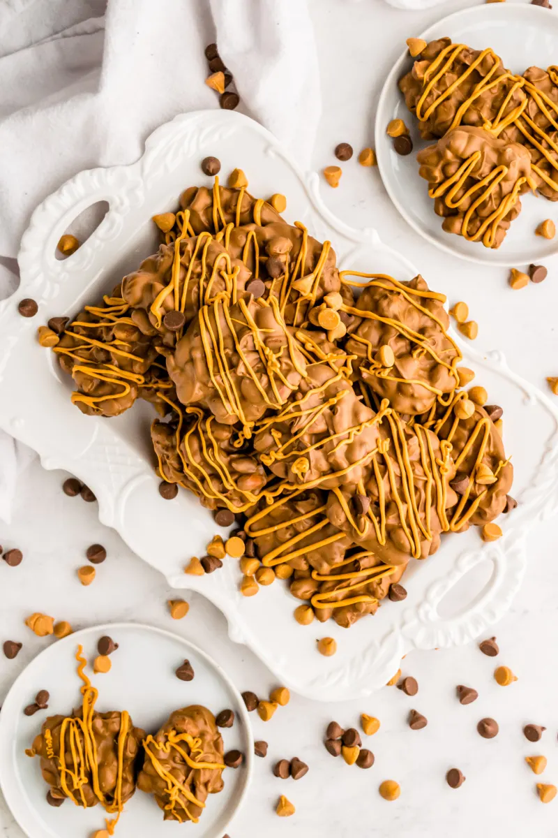 chocolate butterscotch peanut clusters stacked on white plate