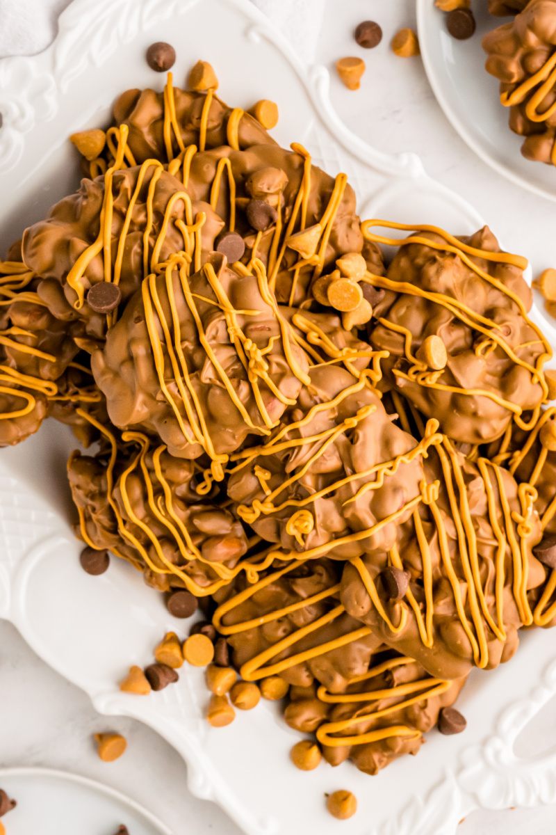 chocolate butterscotch peanut clusters stacked on white plate