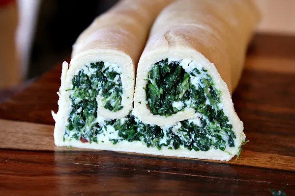 Roll of Spinach Palmiers ready to be cut