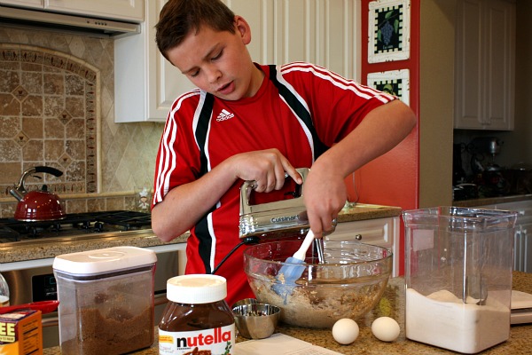 RecipeBoy in the kitchen mixing cookie dough