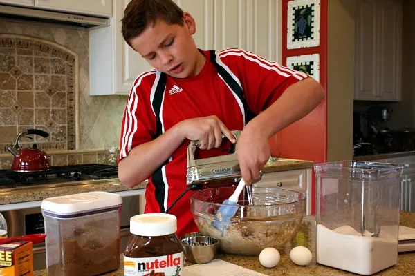 RecipeBoy in the kitchen mixing cookie dough