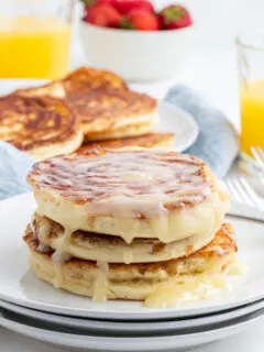 stack of maple cinnamon roll pancakes topped with icing
