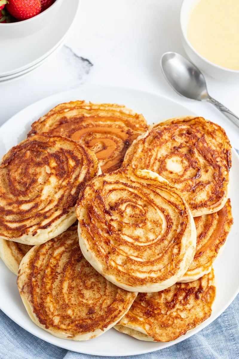 several maple cinnamon roll pancakes on platter