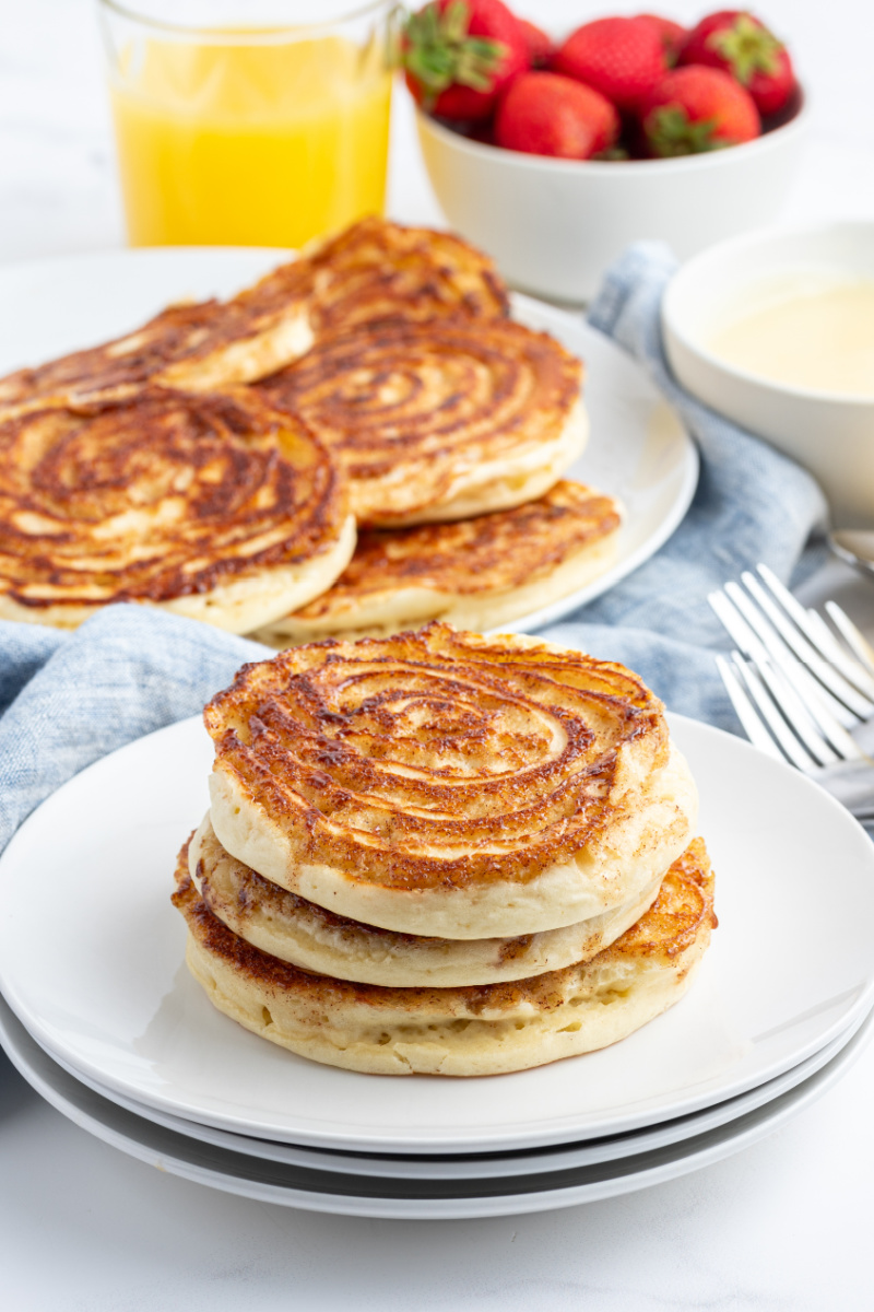 stack of maple cinnamon roll pancakes on a plate