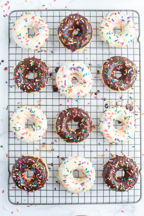 frosted cake batter donuts on a cooling rack