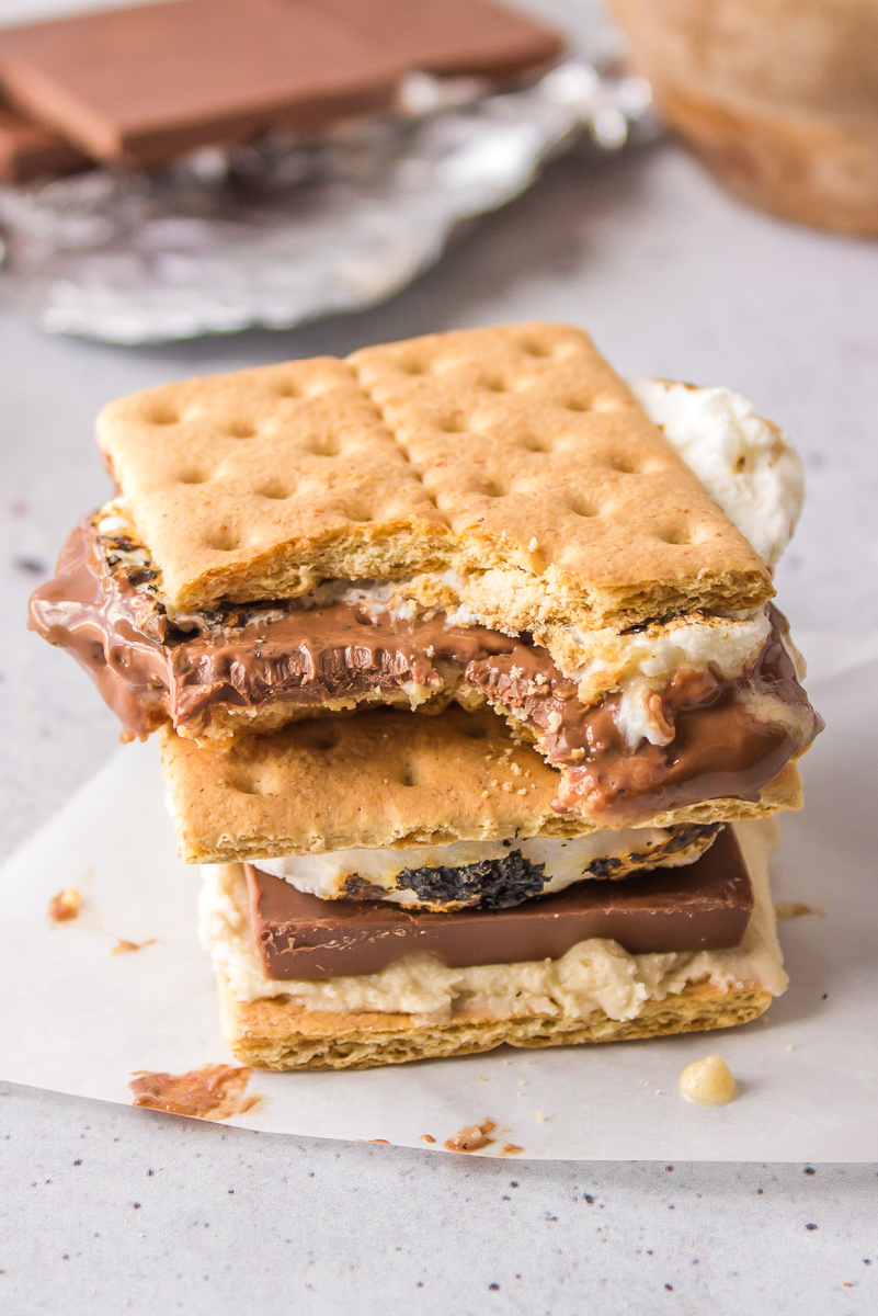 two cookie dough s'mores stacked with bite taken out of one