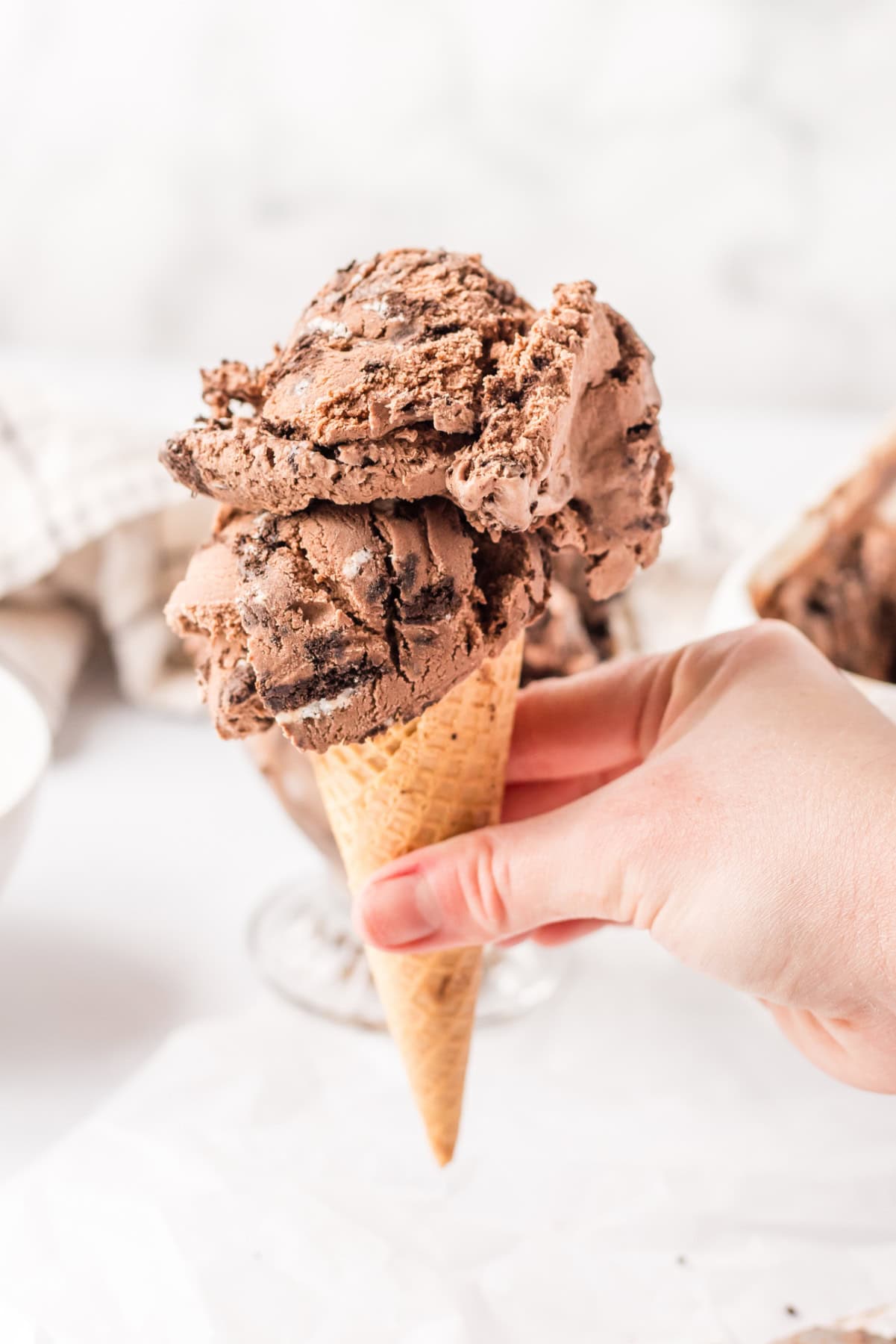 Chocolate cookies and cream ice cream made with a rich cocoa base and loaded with Oreo cookies. Creamy, indulgent and so good! cone with chocolate cookies and cream ice cream