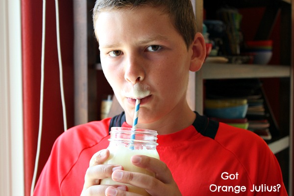 recipeboy drinking orange julius from a jar with an orange julius mustache on his upper lip