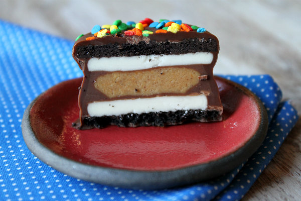 Chocolate Dipped Peanut Butter Cup Stuffed Oreo cut in half