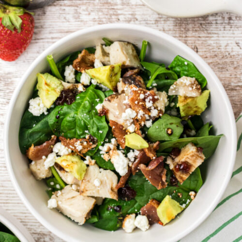 white bowl of the best spinach salad