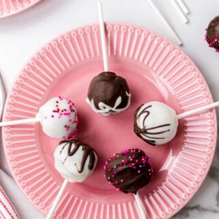 red velvet cake pops displayed on pink plate