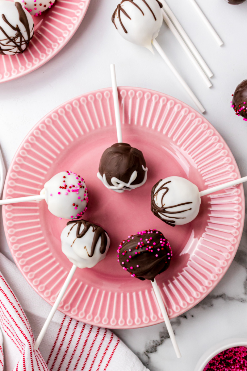 red velvet cake pops displayed on pink plate