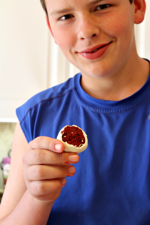 RecipeBoy holding a red velvet cake ball
