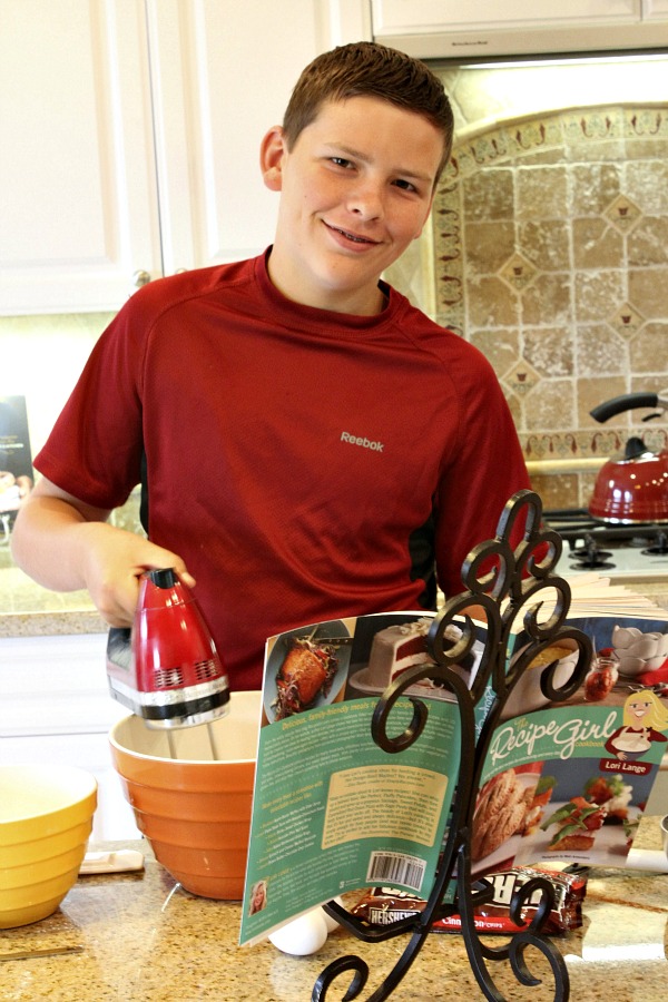 RecipeBoy using a hand mixer in the kitchen