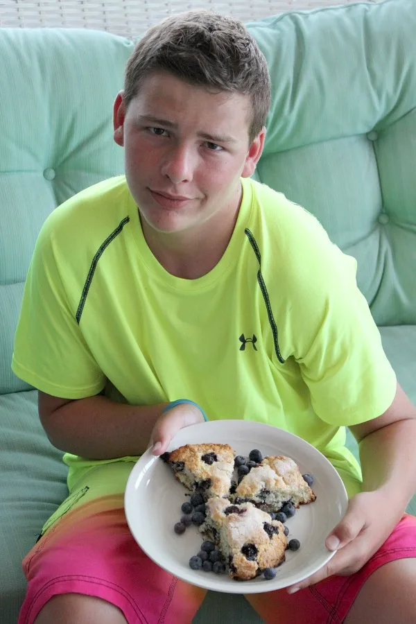 RecipeBoy holding Cape Cod Blueberry Scones on a white plate