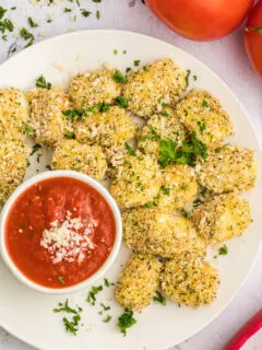 baked mozzarella bites with a dish of dipping sauce