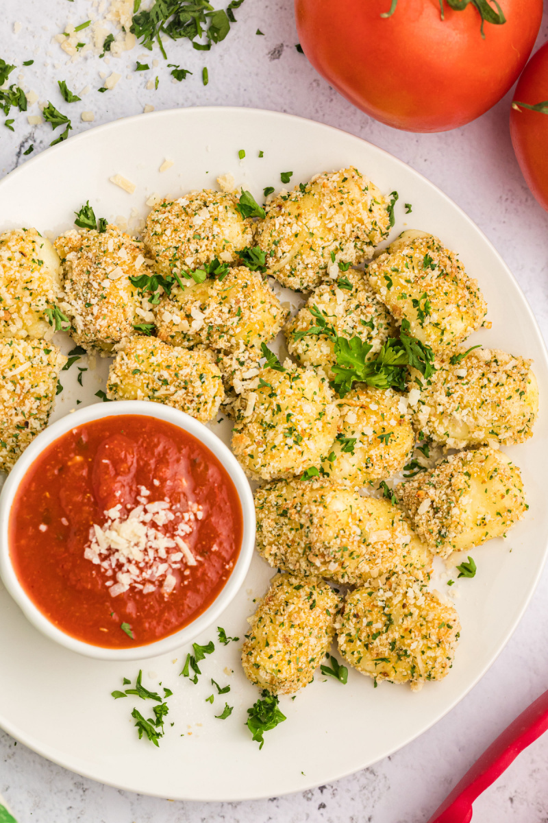 baked mozzarella bites with a dish of dipping sauce