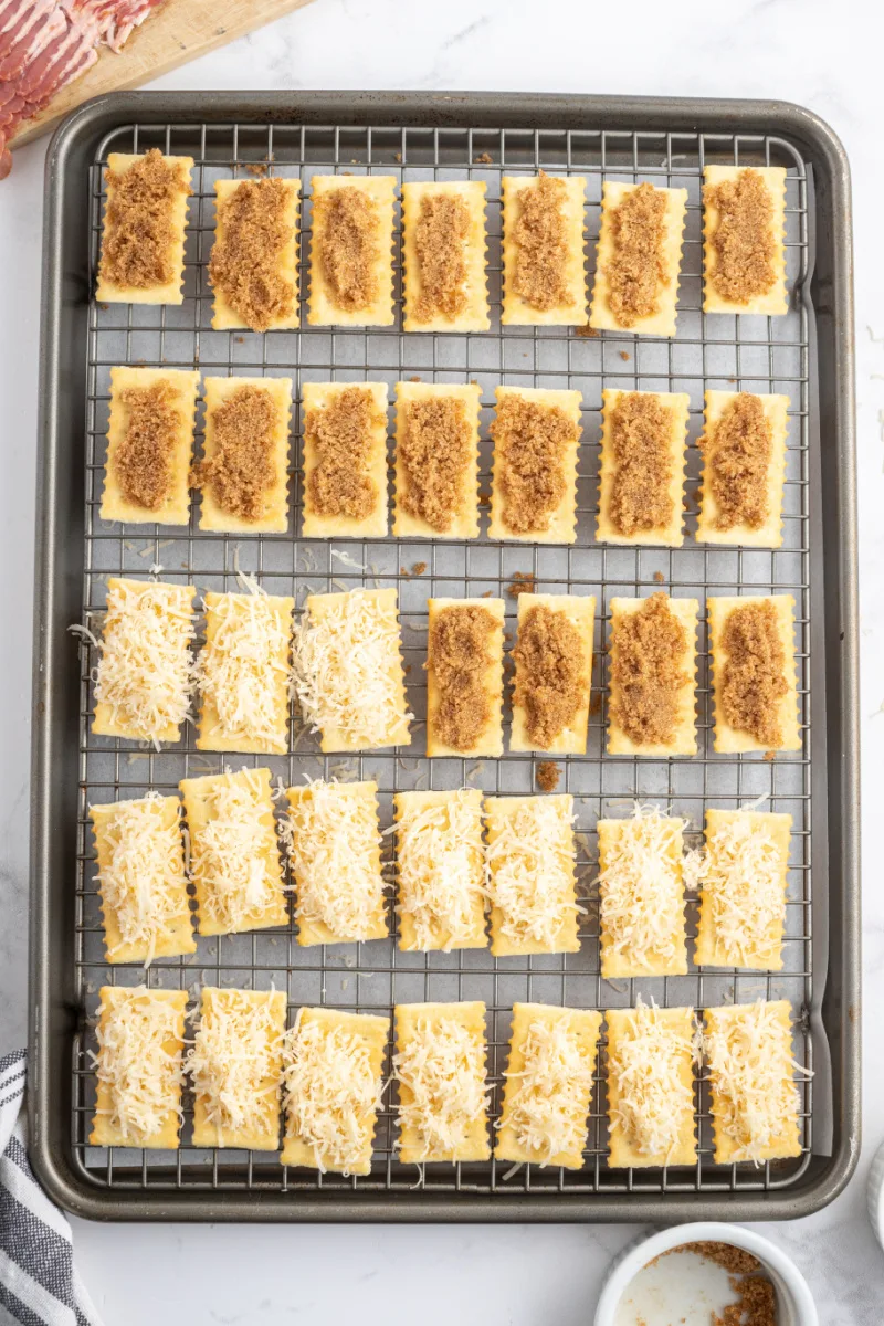 assembling bacon crackers on baking sheet