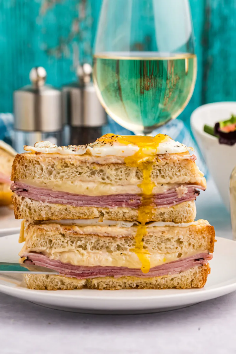 croque madame halves stacked with wine in background