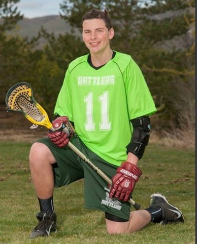 RecipeBoy kneeling with a Lacrosse stick