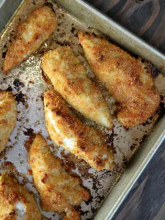 baked parmesan chicken tenders on a baking sheet